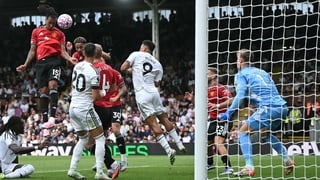 Manchester United's French defender #15 Leny Yoro (L) headers the ball to score the opening goal