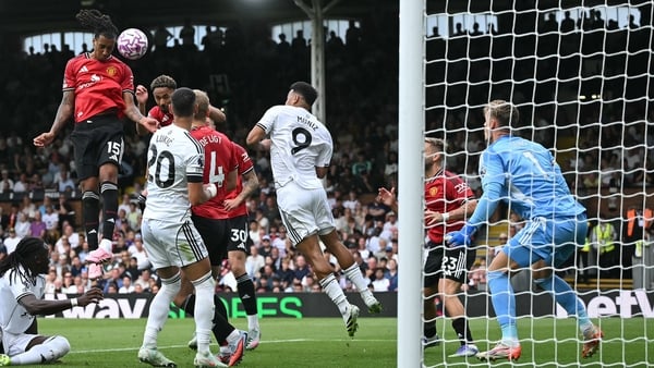 Manchester United's French defender #15 Leny Yoro (L) headers the ball to score the opening goal