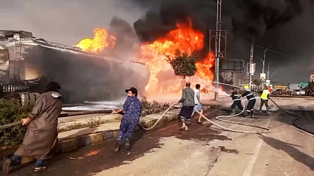 SANAA, YEMEN - AUGUST 24: Firefighters try to extinguish the fire following the Israeli warplanes struck several sites in capital Sanaa, including the presidential palace and power plants, Yemen on August 24, 2025. Flames and smoke rise from the area as military statement claimed that the strikes ta