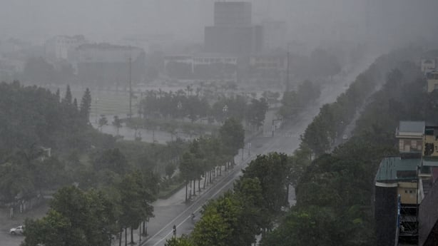 Rain falls above the buildings and a street in Vinh city, Vietnam
