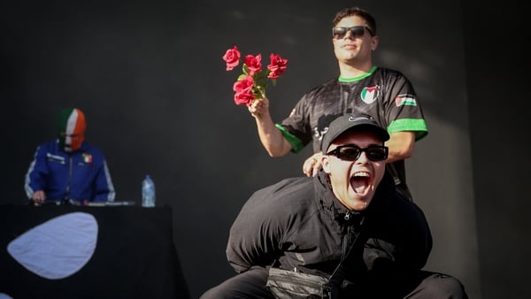 Kneecap perform on stage in front of a Palestinian flag on a screen during a concert at the Rock en Seine music festival in Saint-Cloud, near Paris, on August 24, 2025