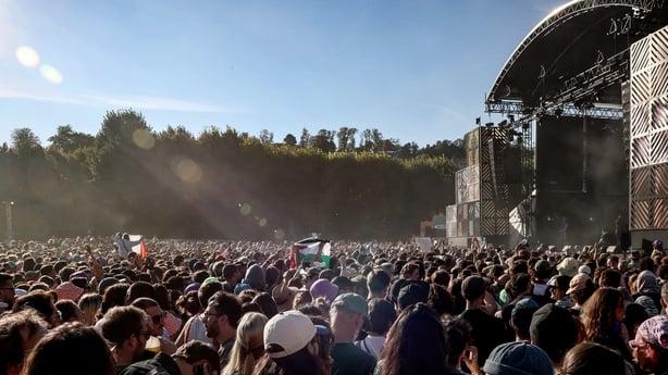 People wave Palestinian flags and cheer during Kneecap's set at the Rock en Seine music festival in Saint-Cloud, near Paris, on August 24, 2025