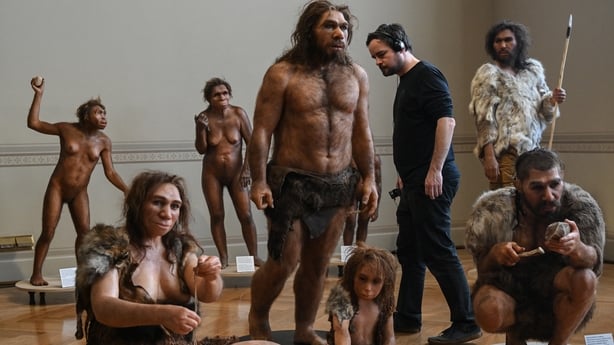 A man looks at the hyperrealistic artistic reconstruction of the human ancestors in the National Museum of Prague