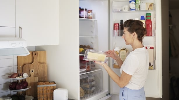 woman clearing out her fridge