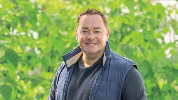 Neven Maguire standing in front of green produce growing in a garden