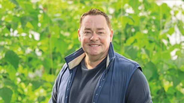 Neven Maguire standing in front of green produce growing in a garden