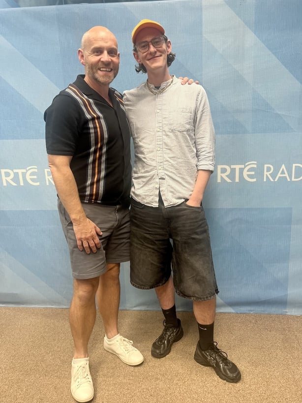 Two men posing for a photo and smiling