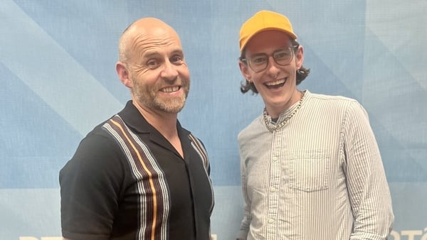 Two men posing for a photo and smiling