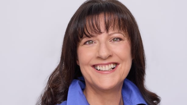 Picture of a lady in a purple blouse
