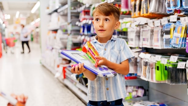 Mother her son at stationery shopping in a store, his son is angry because he didn't get what he wanted
