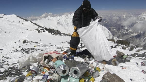 This picture taken on May 23, 2010 shows a Nepalese sherpa collecting garbage, left by climbers, at an altitude of 8,000 metres during an Everest clean-up expedition