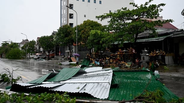 A corrugated iron roof lies on the middle of a road after Typhoon Kajiki passed through the Nghe An province in Vietnam 