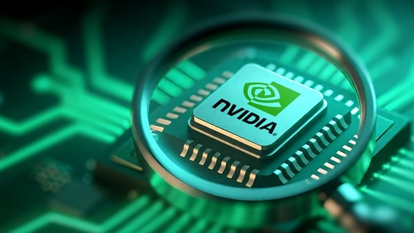 A Nvidia chip is seen through a magnifying glass on a green motherboard