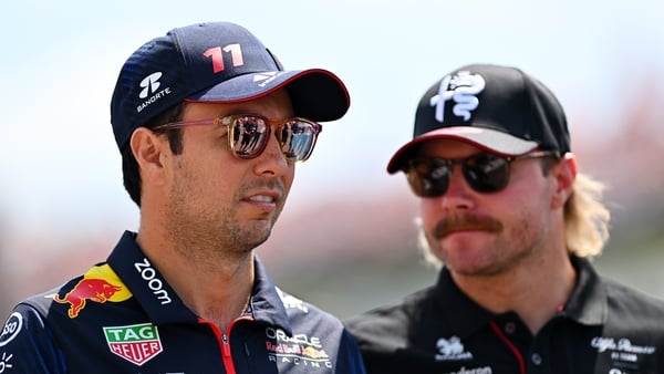 Sergio Perez of Mexico and Oracle Red Bull Racing talks with Valtteri Bottas of Finland and Alfa Romeo F1 on the drivers parade prior to the F1 Grand Prix of Hungary at Hungaroring on July 23, 2023 in Budapest, Hungary.