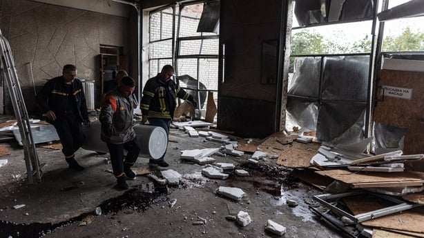 Firefighters clear debris after an attack at a fire station in Kostiantynivka, Ukraine
