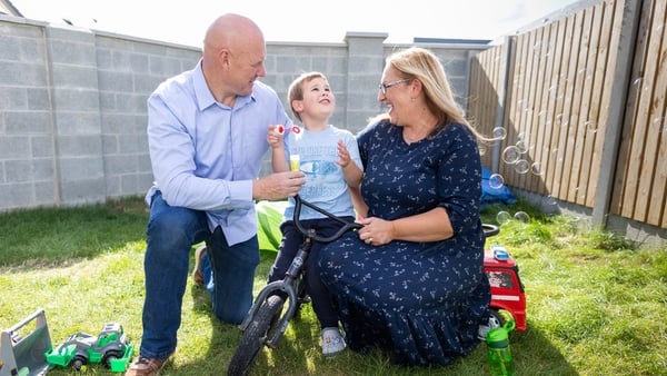 A family play in their back garden