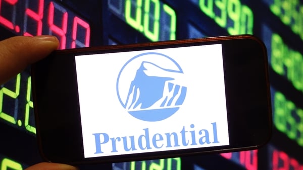 Image of the Prudential Insurance logo on a smartphone against a digital background