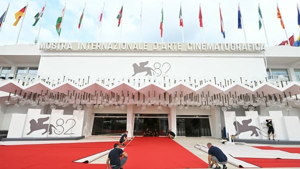 Workers set the red carpet at the Palazzo del Cinema ahead of the opening ceremony of the 82nd Venice Film Festival at the Venice Lido, on 26 August, 2025
