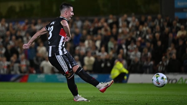 GRIMSBY, ENGLAND - AUGUST 27: Darragh Burns of Grimsby Town scores the team's thirteenth penalty in the penalty shoot out during the Carabao Cup Second Round match between Grimsby Town and Manchester United at Blundell Park on August 27, 2025 in Grimsby,
