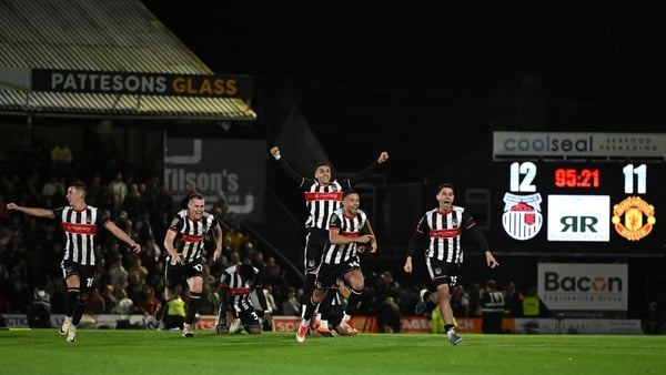 Players of Grimsby Town celebrate after beating Manchester United on penalties in Carabao Cup, August 2025