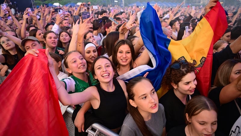 Moldovans take part in a celebration on the country's 34th Independence Day during a concert in the front of the Moldovan government headquarters in Chisinau