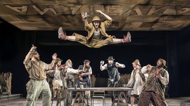 Cast of Fiddler On The Roof with one of them in mid air