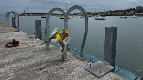 Flowers left at the scene in Wicklow Harbour where a man died after getting into difficulty while swimming