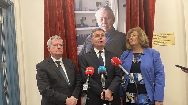 Minister Paschal Donohue beside a picture of Irish-American philanthropist Chuck Feeney