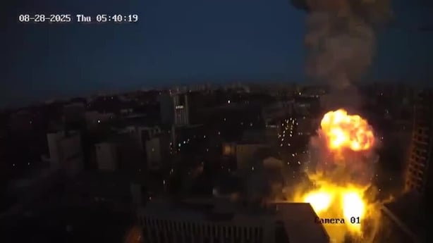 A fireball is seen at nighttime from above after a missile strike in Kyiv