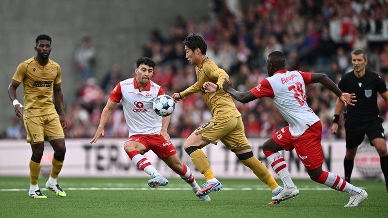 Daichi Kamada of Crystal Palace is pressured by Patrick Metcalfe and Solomon Owusu of Fredrikstad FK