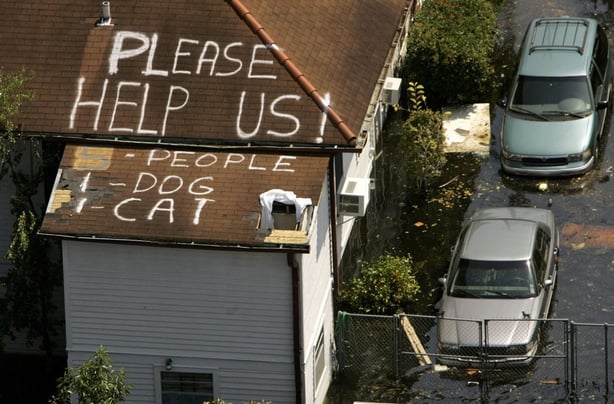 A plea for help appears on the roof of a home flooded in the aftermath of Hurricane Katrina