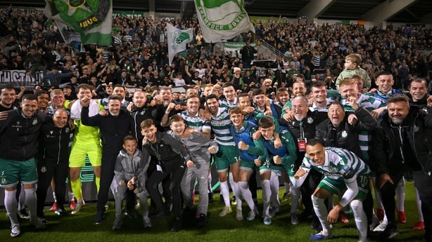 Shamrock Rovers players, along with manager Stephen Bradley and his son Josh, centre, celebrate with supporters after their side's victory in the UEFA Conference League Play-off Round second leg match between Shamrock Rovers and CD Santa Clara at Tallaght Stadium 
