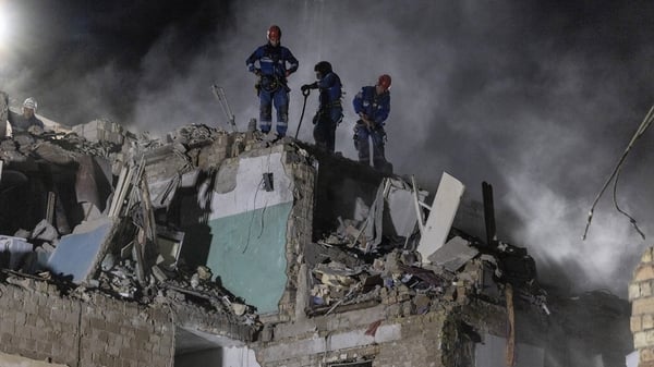 KYIV, UKRAINE - Emergency rescue workers search for survivors after Russia launched a massive attack on Kyiv August 28, 2025 in Kyiv, Ukraine. The attack was the second largest since the full-scale invasion killing at least 21 people including four childr