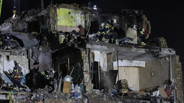  Emergency rescue workers search for survivors after an overnight bombardment by Russian forces in Kyiv