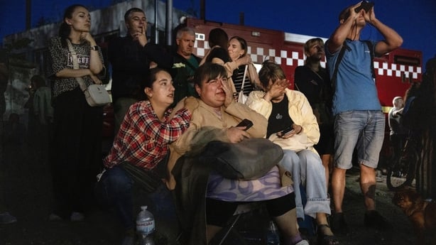 KYIV, UKRAINE - Iryna Kutsenko (center) is comforted as friends and family waits for news about her mother while emergency rescue workers search for survivors after Russia launched a massive attack on Kyiv August 28, 2025 in Kyiv, Ukraine. The attack was the second largest since the full-scale invas
