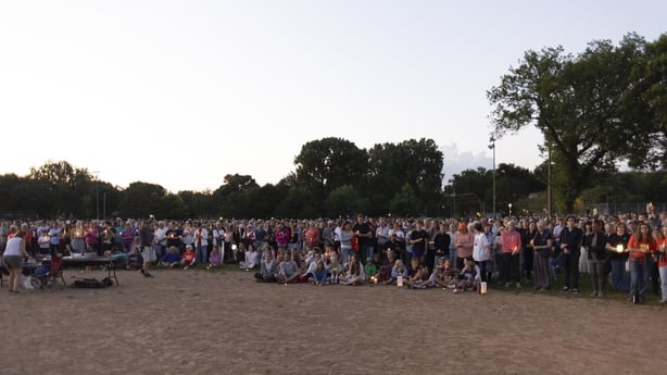 People gather at Lynhurst Park for a candle light vigil