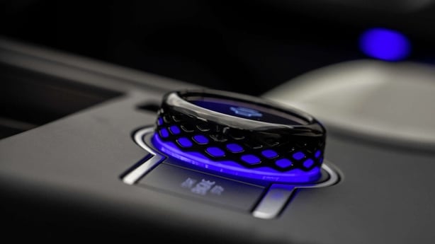 A switch inside a car with blue lights