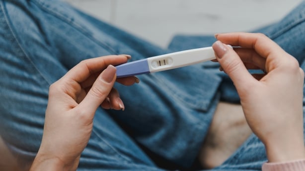 woman with positive pregnancy test