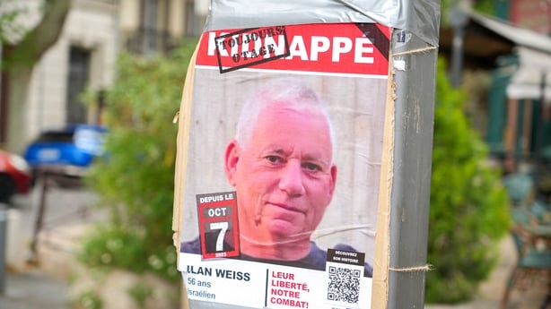 A poster of a photo of Israeli hostage Ilan Weiss