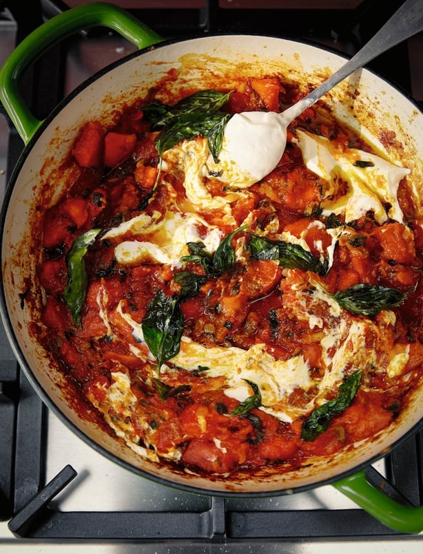 A pot of papaya stew with basil