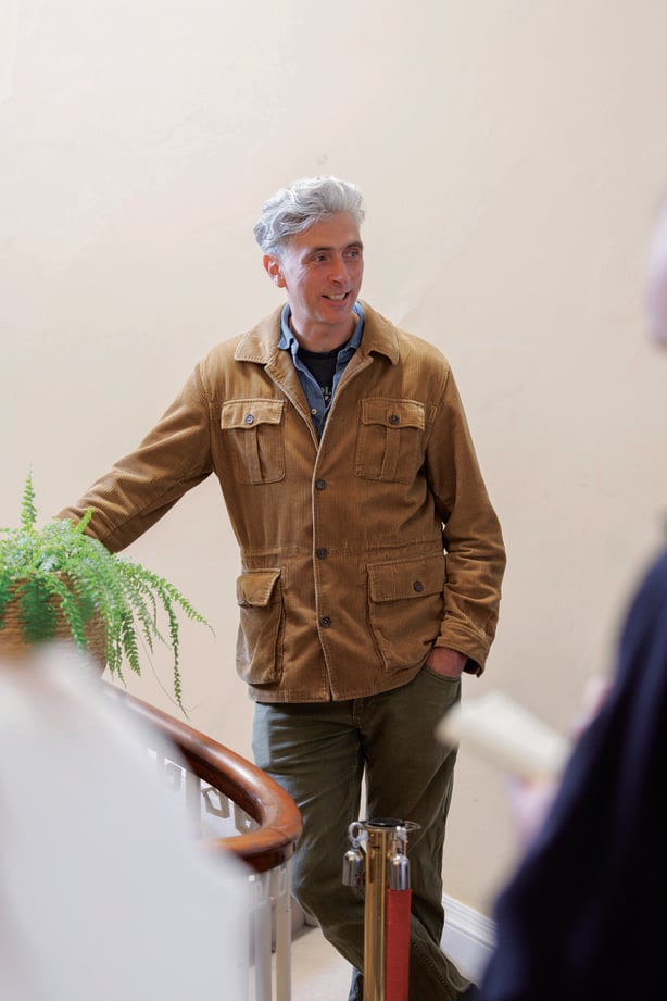 Alex Mount Charles standing by a staircase