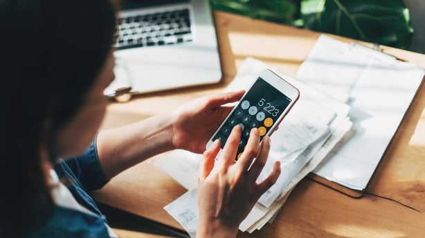 Close up Business woman using calculator and laptop for do math finance on wooden desk in office and business working background, tax, accounting, statistics and analytic research concept