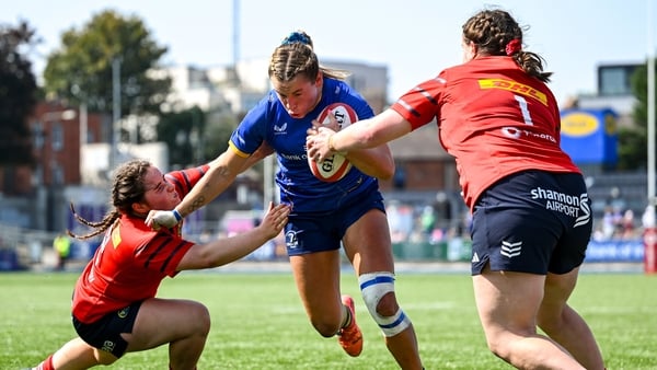 16 August 2025; Kathy Baker of Leinster on her way to scoring her side's second try despite the efforts of Munster players Aoife Fleming, left, and Gráinne Burke during the Vodafone Women’s Interprovincial Championship Round 2 match between Leinster and M