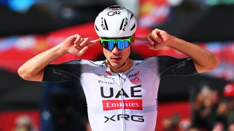 Juan Ayuso celebrates at the finish line