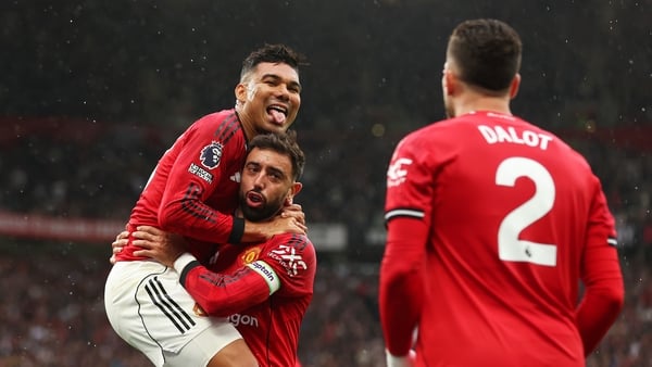MANCHESTER, ENGLAND - AUGUST 30: Casemiro and Bruno Fernandes of Manchester United celebrate after Josh Cullen of Burnley (not pictured) scores his teams own goal during the Premier League match between Manchester United and Burnley at Old Trafford on Aug