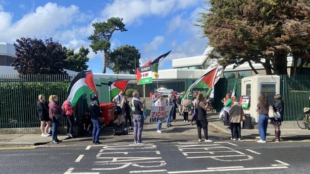 People fly Palestinian flags outside the German embassy in Dublin