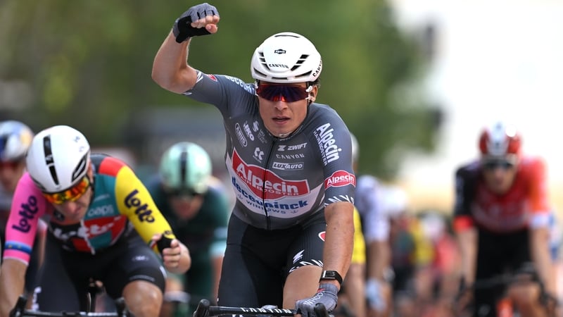 Jasper Philipsen celebrates at the finish line