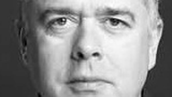 black and white headshot of actor Jonathan White, looking directly to camera, unsmiling
