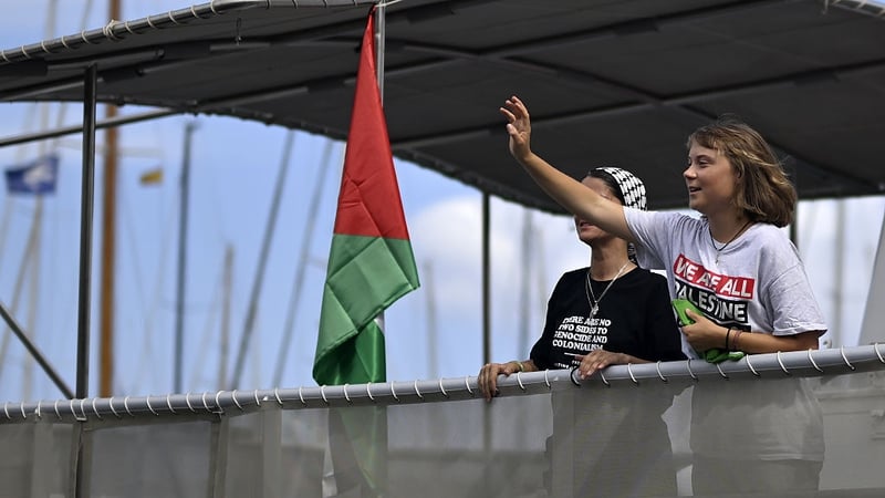 Swedish activist Greta Thunberg waves from the Global Sumud Flotilla as it sets sail from Barcelona heading towards Gaza