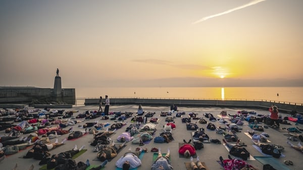 People take a yoga class as the sun rises